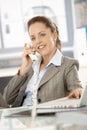 Attractive businesswoman talking on phone smiling Royalty Free Stock Photo