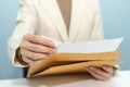 Attractive businesswoman hand open business report from document envelope and working on desk Royalty Free Stock Photo