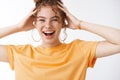 Attractive carefree young girl freckles clean skin stylish messy curly hairbun having fun laughing enjoying wild Royalty Free Stock Photo
