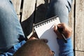 Attractive casually dressed young black male student making notes in copybook, preparing for lesson at university. Royalty Free Stock Photo