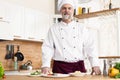 Attractive Caucasian chef standing in a restaurant kitchen