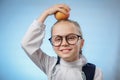 Attractive Caucasian Girl With Apple On Blue Background. Schoolgirl Smiling. Happy Child With Fresh Fruit - Emotional