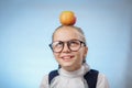 Attractive Caucasian Girl With Apple On Blue Background. Schoolgirl Smiling. Happy Child With Fresh Fruit - Emotional Portrait