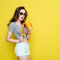 Attractive Caucasian joyful woman with a paper cup of juice and Royalty Free Stock Photo