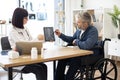 Specialist discussing x-ray image with wheelchair user