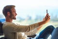 Attractive caucasian man taking a selfie with his mobile phone
