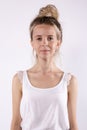 Caucasian teen girl looks at camera with smile. White background