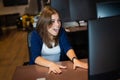 Attractive caucasian woman enjoying success at work desk in office. Royalty Free Stock Photo