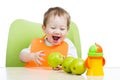 Attractive child with green apples healthy food