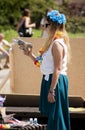 Attractive college girl shooting soap bubbles from toy gun
