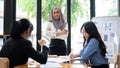 A confident Asian Muslim businesswoman stands in front of the meeting with her arms crossed Royalty Free Stock Photo