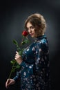 Attractive confident girl holding red rose. Royalty Free Stock Photo