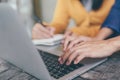 Attractive confident two business women in smart working on laptop creative in her work station. and woman hand holding a pen and Royalty Free Stock Photo