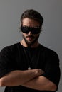 attractive cool guy wearing sunglasses and crossing arms Royalty Free Stock Photo