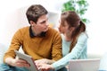 Attractive couple consulting something on a touchpad