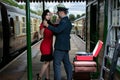 Attractive couple dance on railway station platform with portable record player Royalty Free Stock Photo