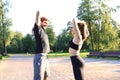 Attractive couple doing stretch together and smiling while working out in park outdoors Royalty Free Stock Photo