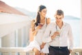 Attractive couple drinking cocktails ,enjoying summer vacation.Smiling,attracted to each other.Flirting and seduction Royalty Free Stock Photo