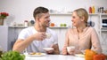 Attractive couple drinking tea after meal for better digestion, water balance