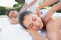 Attractive couple enjoying couples massage poolside Royalty Free Stock Photo