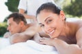 Attractive couple enjoying couples massage poolside Royalty Free Stock Photo