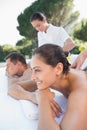 Attractive couple enjoying couples massage poolside Royalty Free Stock Photo