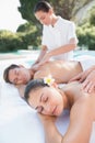 Attractive couple enjoying couples massage poolside Royalty Free Stock Photo