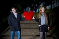 Attractive couple fighting over a love heart pillow