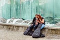 Attractive couple with guitars sit near the fountain, use the mo