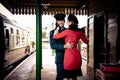 Attractive couple dance on railway station platform with portable record player Royalty Free Stock Photo