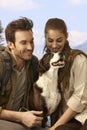 Attractive couple hiking with dog