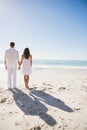 Attractive couple holding hands and watching the sea Royalty Free Stock Photo