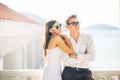 Attractive couple looking at amazing sea view.Enjoying sun and sunny weather and breathing in fresh ocean air.Enjoying moment