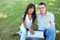 Attractive Couple in Park with Laptop Royalty Free Stock Photo