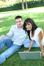 Attractive Couple in Park with Laptop Royalty Free Stock Photo