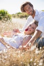 Attractive couple relaxing in the countryside smiling at camera Royalty Free Stock Photo