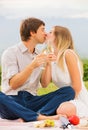 Attractive couple on romantic afternoon picnic kissing Royalty Free Stock Photo