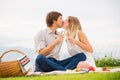 Attractive couple on romantic afternoon picnic kissing Royalty Free Stock Photo