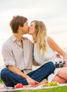 Attractive couple on romantic afternoon picnic kissing Royalty Free Stock Photo