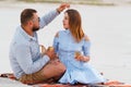 Attractive couple sitting together, looking each other, happy co Royalty Free Stock Photo