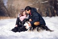 Attractive couple smiling and having fun in winter park with their husky dog Royalty Free Stock Photo