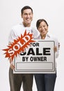 Attractive couple with sold sign Royalty Free Stock Photo
