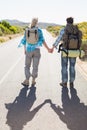 Attractive couple standing on the road holding hands