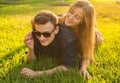 Attractive couple of teenagers lying in the grass smiling and have fun Royalty Free Stock Photo