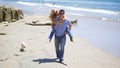 Attractive Couple with their Labrador Retriever Puppy at the Beach Royalty Free Stock Photo