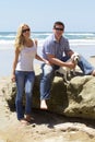 Attractive Couple with their Labrador Retriever Puppy at the Beach Royalty Free Stock Photo