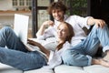 Attractive couple using laptop while sitting on couch Royalty Free Stock Photo