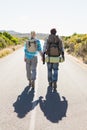 Attractive couple walking on the road holding hands