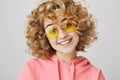 Attractive crazy girl never sits at home on weekends. Portrait of funny happy curly-haired woman in stylish sunglasses