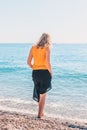 Attractive cute fashion blonde on beach steps into sea Royalty Free Stock Photo